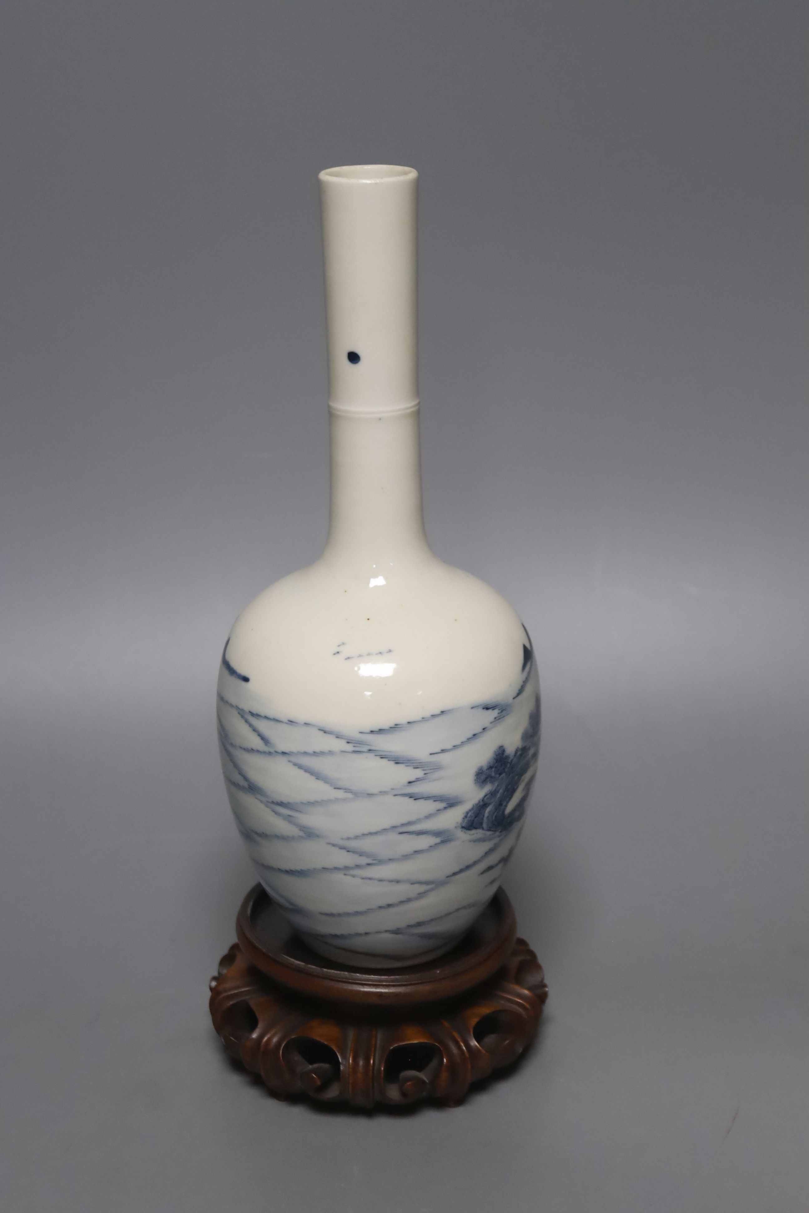 A Chinese blue and white bottle vase, with hardwood stand 23.5cm.